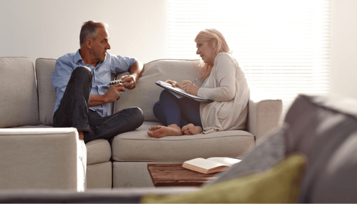 old couple discussing on couch